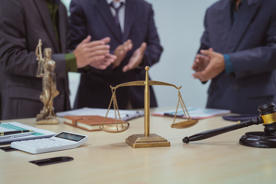 Three lawyers in a meeting at the table in an office, discussing business, civil and commercial law, labor law, marketing and advertising law,offering legal consulting and case management services.