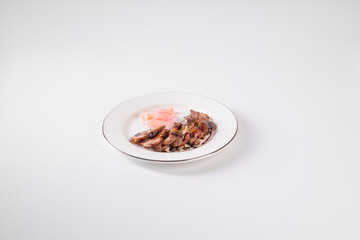 Elegant plate of sliced cured meat and prosciutto, arranged neatly on a white plate against a minimalistic background.