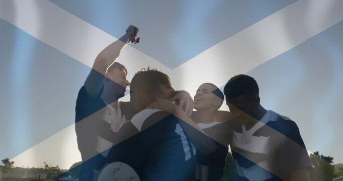 Animation of flag of scotland over diverse male rugby players celebrating