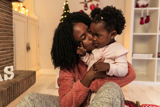 Tender Christmas Kiss between Mother and Child - Powered by Adobe