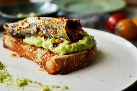 homemade open faced sandwich, with avocado sauce and spicy sardine