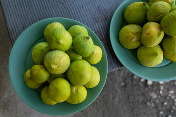 Top view of green figs in a plate are ready to eat in the country.
