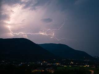 Lightning discharge over the foothills of the southern limestone Alps near Lake Garda, Italy