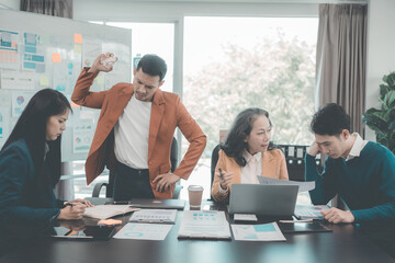 A group of business people are in a stressful meeting, arguing, disagreeing, and arguing while presenting a marketing plan in a poor economy.