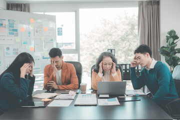 A group of business people are in a stressful meeting, arguing, disagreeing, and arguing while presenting a marketing plan in a poor economy.