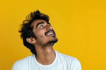 Fototapeta premium Young Indian man feeling inspired and proud on yellow background.