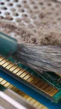 Cleans from dust memory module for PC with contact pins. Heat spreader transfer energy to heat sink or exchanger. Service center worker. Random Access Memory or electronic board RAM