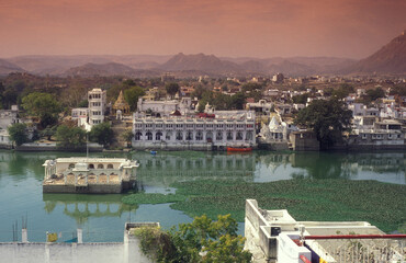 Architectur with Palace and Houses on the Pichhola Lake in the Town of Udaipur in the Province of Rajasthan in India. India, Udaipur, January, 1998