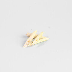 Isolated fresh lemongrass stalks on a plain white background, showcasing their natural texture and vibrant color.