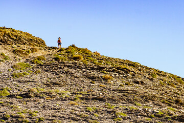 Woman walk on spanish coast, take photo with camera