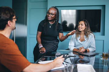 Black business woman having a discussion with her team in a meeting