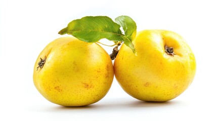 Two yellow apples with green leaves against a white background.
