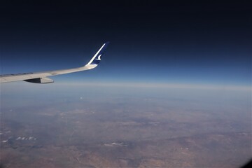 Wing of Turkish Airlines plane flying over Istanbul, Turkey.