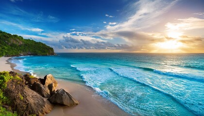 The sun is beautifully setting over the vast ocean on a rocky beach