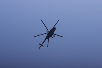 Kyiv, Ukraine - 24 August 2021: A Ukrainian Mi-8 military helicopter without weapons flies overhead during an Independence Day parade, viewed from below.