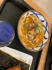Japanese food. Carbonara Curry Udon Marugame Thick udon noodles in a savory flavored broth, served with sliced meat or tempura, with green onion and egg  offering a  hearty dish.