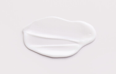 cosmetic smear of creamy texture on gray background