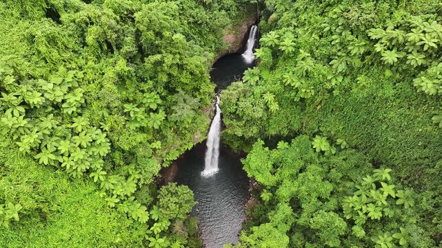 Amazing drone view of cascade waterfalls hidden in dense jungle forest. Tavoro, Bouma, Fiji.