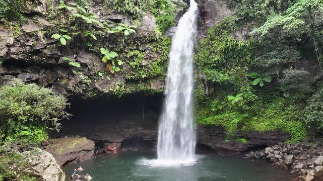 Tavoro Waterfalls, Bouma, Fiji. Pristine natural falls in jungle, Taveuni Island. Aerial crane, people swim