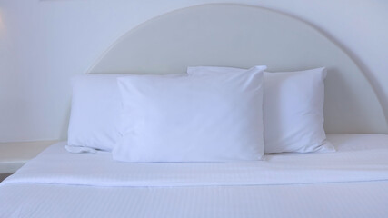 The white pillows on the bedroom on a bed with duvet case bedspread isolated on white background
