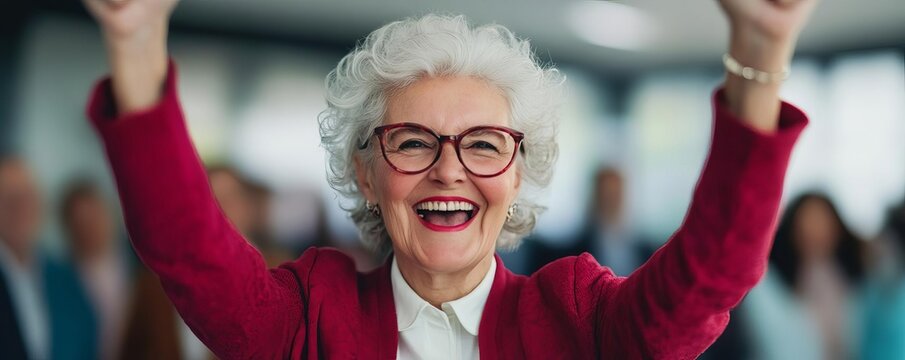 Elderly woman celebrating a corporate milestone with her team, leadership and success