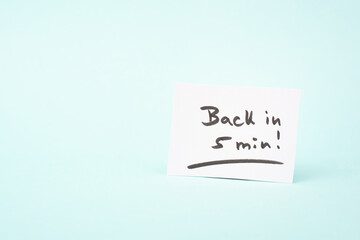 Back in 5 min is standing on a paper, message, working break, be right back

