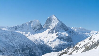 Fototapeta na wymiar Majestic snow-capped mountain peaks under a clear blue sky in winter