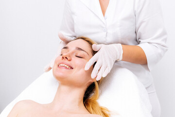 Elegant cosmetic clinic: a young woman receives professional care. Perfect for promoting beauty treatments and services, highlighting luxury and personalized attention.