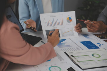 Close up of Business team analyzing income charts and graphs with modern laptop computer. Business analysis and strategy concept.