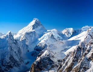 Majestic snow-capped mountain peaks under a clear blue sky in winter