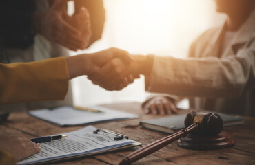Lawyer shaking hands with a client making about documents, contracts, agreements, cooperation...
