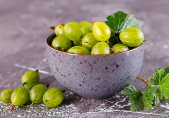 Fresh gooseberry in gray bowl on a table