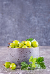 Fresh gooseberry in gray bowl on a table