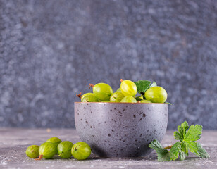 Fresh gooseberry in gray bowl on a table