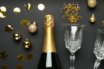 Flat lay composition with confetti and bottle of sparkling wine on grey background