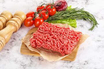Raw minced beef meat on cutting board