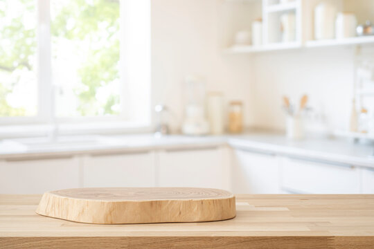Fototapeta Table top with empty wooden podium for product montage on blur kitchen window interior background