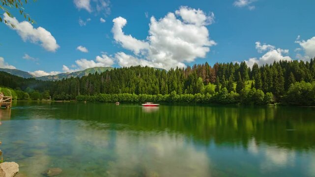 Karagol Lake in Savsat district of Artvin province in Turkey. Time lapse 4k video of a lake and motion of the clouds and boats. Visit Turkey concept video.