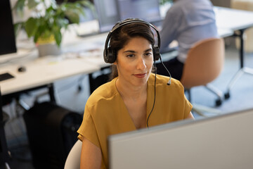 Businesswoman with headset on a video call in an office