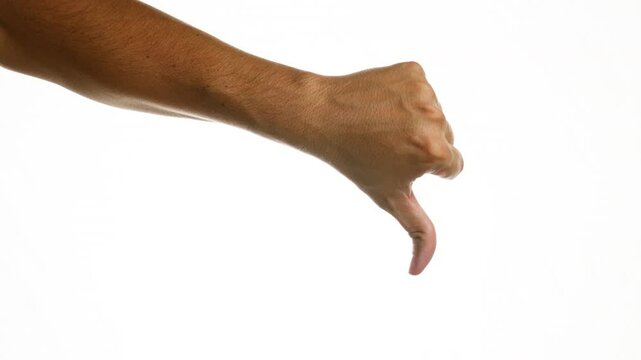 Man's hand showing thumbs down gesture on isolated white background indicating disapproval or dislike