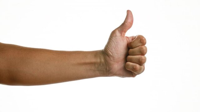 Hands giving a thumbs up gesture over isolated white background suggesting approval, positivity, success, and agreement