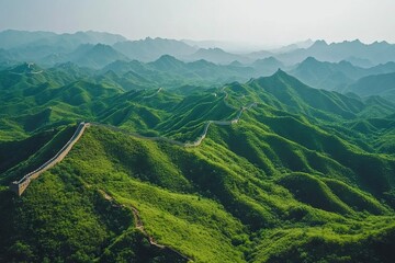 A scenic view of the Great Wall of China winding through rugged terrain and lush valleys