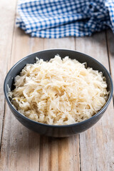 Sauerkraut in a bowl on wooden table. Traditional german food