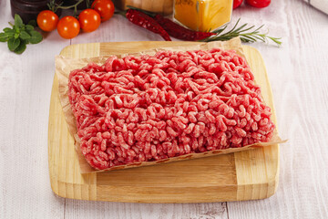 Raw minced beef meat over board