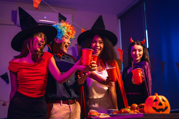 Asian friends, middle-aged man and young woman, enjoy Halloween office party with vampire costumes,...