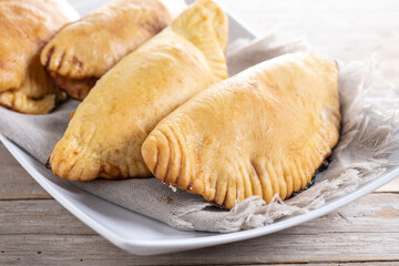 Pumpkin empanadillas for Halloween or Thanksgiving's Day on wooden table