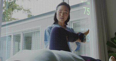 Animation of cardiograph over senior asian woman exercising with female nurse - Powered by Adobe