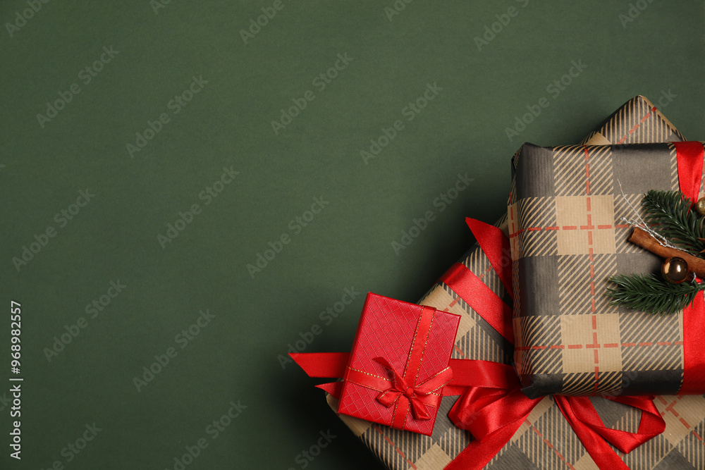 Sticker Christmas gift boxes on dark green background, top view. Space for text