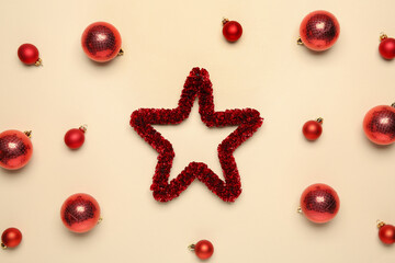 Flat lay composition with Christmas balls and decorative star on beige background