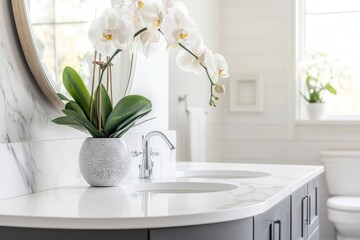 Bathroom with dark vanity and granite countertop. Plants and towels sit on the vanity. Marble tiles line the shower. Lights are on.
